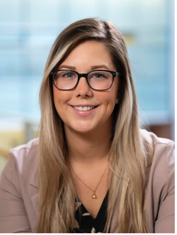 Sabrina Bartlett, a professional woman with shoulder-length hair, wearing business attire and smiling warmly.